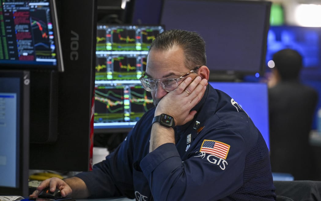 A trader works on the floor of the New York Stock Exchange (NYSE) at the opening bell on April 8, 2025, in New York City. Wall Street stocks surged higher early Tuesday as global markets rallied following deep losses in hopes of trade agreements that would remove US President Trump's heavy tariffs. All three major US indices were up more than three percent in early trading as Trump described an upbeat call with the head of South Korea while US Treasury Secretary Scott Bessent said Japan had sought quick negotiations. (Photo by ANGELA WEISS / AFP)