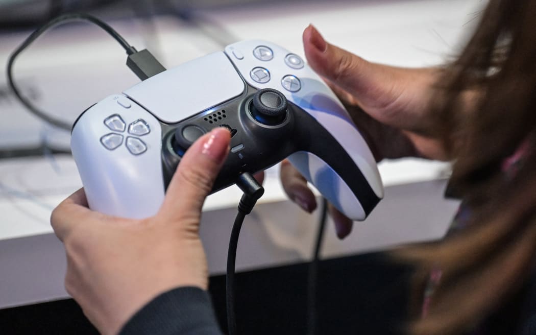A member of the media tries out Sony's new PlayStation 5 console during the preview day for the annual Tokyo Game Show at Makuhari Messe in Chiba City, Chiba Prefecture on September 26, 2024.