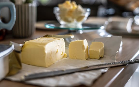 A block of butter, with several chunks awaiting a good bit of toast