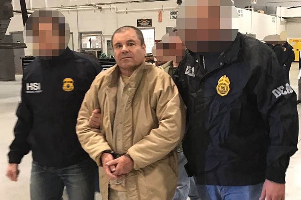 This handout picture released by the Mexican Interior Ministry on January 19, 2017 shows Joaquin Guzman Loera aka "El Chapo" Guzman escorted in Ciudad Juarez by the Mexican police.