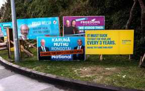 A tongue-in-cheek TradeMe advertisment next to election hoardings that reads: ‘It must suck to fight for your job every 3 years. Maybe try something new?’