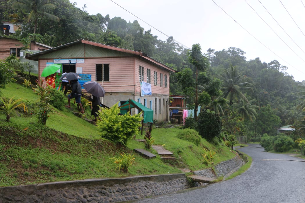 Voters braving the wet conditions to vote in Suva