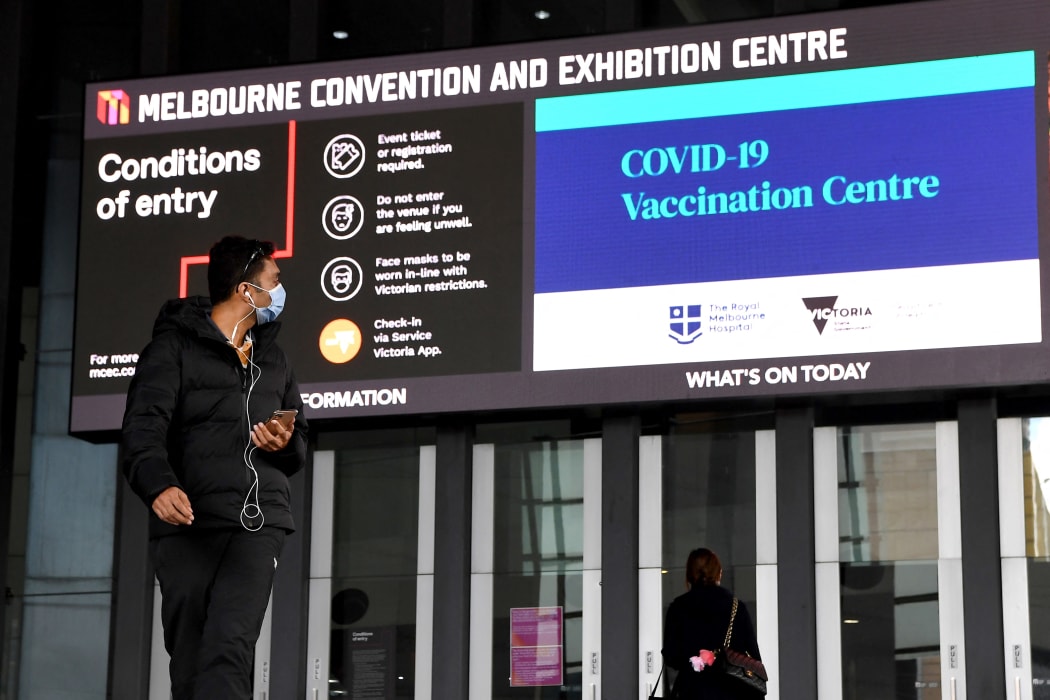 A man walks past a Covid-19 vaccination centre in Melbourne.
