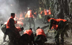 Rescuers search through rubble in the town of Jiuzhaigou after a 6.5-magnitude earthquake struck Sichuan province, China