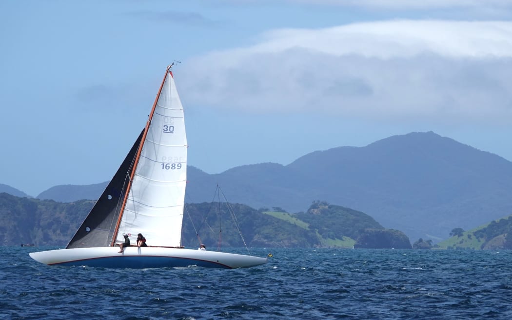 Wooden boat winner Caprice sails past Rakaumangamanga, a mountain of great significance to Ngāpuhi.