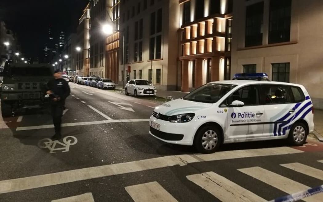Police stand guard in the city centre of Brussels, where a man is alleged to have attacked soldiers with a knife and was shot.