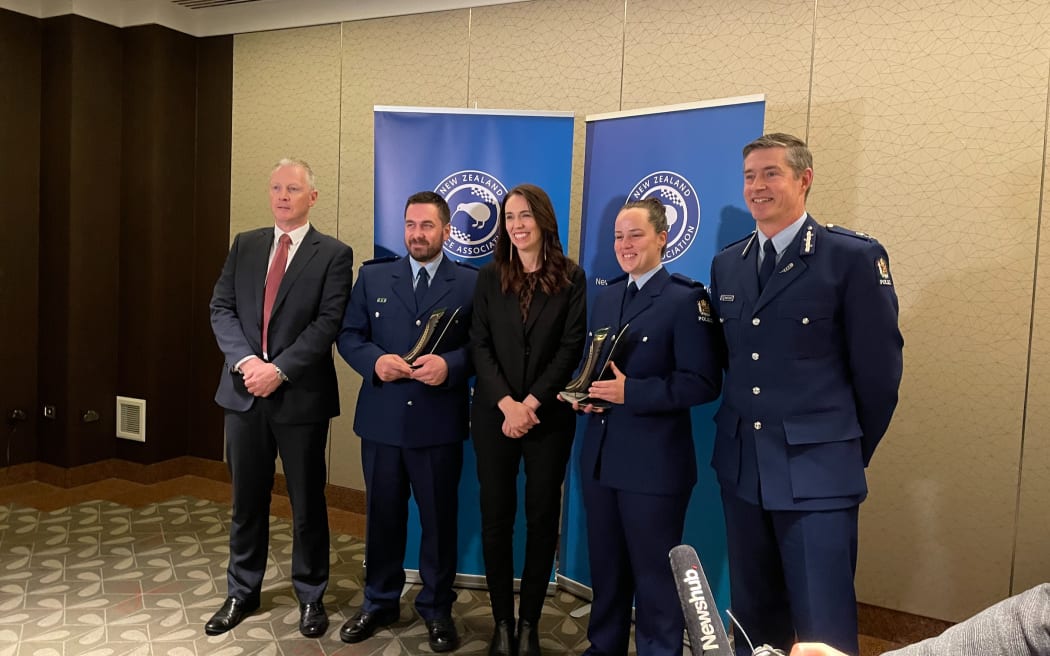 From left NZ Police Association president Chris Cahill, Detective Constable Jeremy Toschi, Prime Minister Jacinda Ardern, Constable Sophie Allison, and Police Commissioner Andrew Coster.