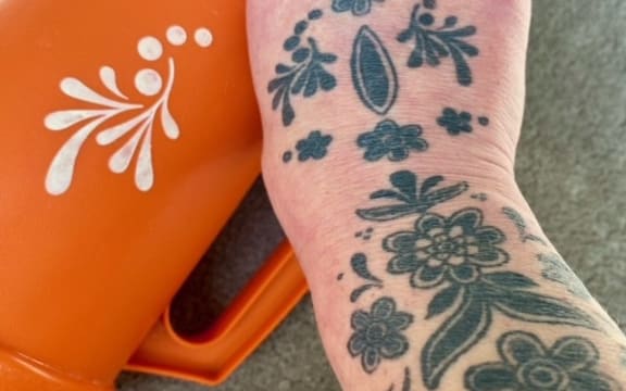 Nik Watts had the flower design that's on the original Tupperware jug tattooed on her hand