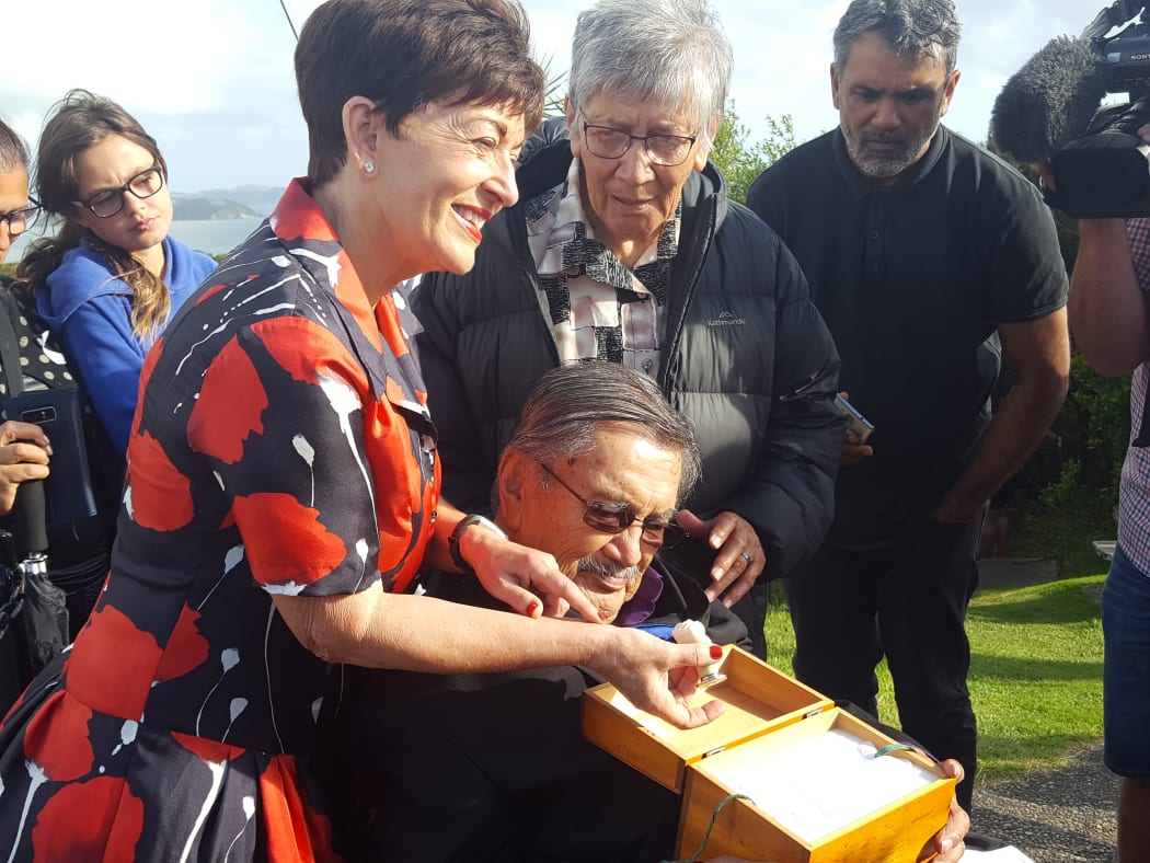 Governor-General Dame Patsy Reddy with Ngāti Hine elder Raumoa Kawiti examining the seal given to his tupuna by Queen Victoria.
