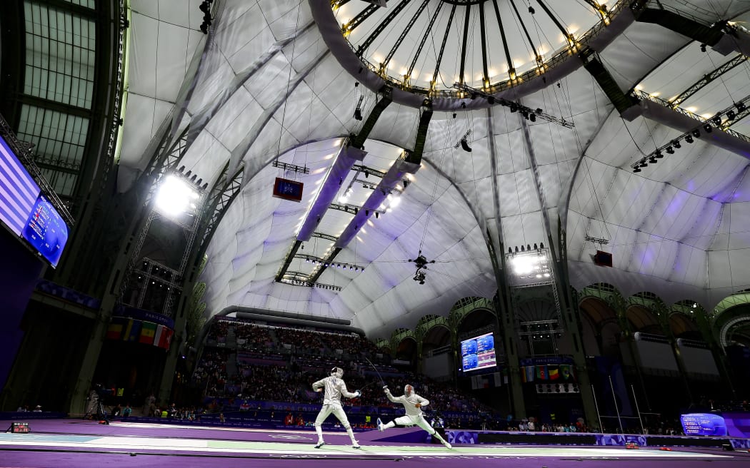 APITHY Bolade of France, SZATMARI Andras of Hungarian, Men's Sabre Individual Fencing during the Olympic Games Paris 2024 on 27 July 2024 at Le Grand Palais in Paris, France - Photo Gregory Lenormand / DPPI Media / Panoramic (Photo by Gregory Lenormand - DPPI Media / DPPI Media / DPPI via AFP)