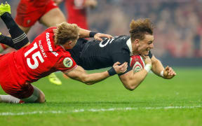 Ruben Love dives past Blair Murray to score against Wales.