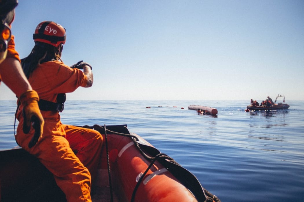 Members of the German migrant rescue NGO Sea-Eye on a rubber boat during an operation to rescue people from small boats in distress off the Libyan coast, before bringing them on board their vessel "Alan Kurdi".