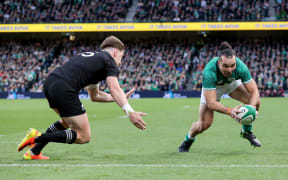 Ireland's James Lowe scores the opening try despite Jordie Barrett.