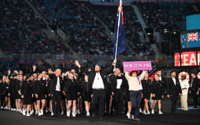 New Zealand's flag bearers Tom Walsh and Joelle King lead their country's athletes in the Parade of Nations during the opening ceremony for the Commonwealth Games at the Alexander Stadium in Birmingham, central England, on 28 July 2022.