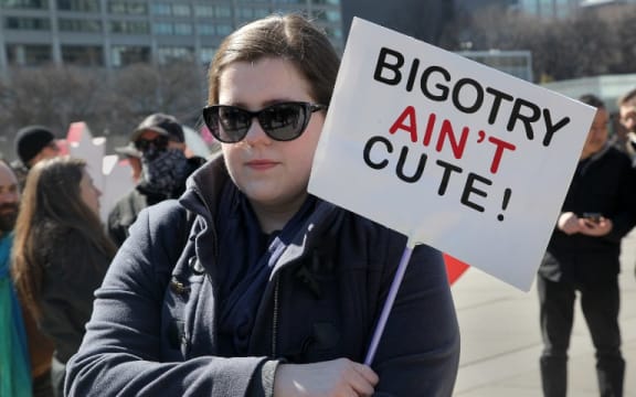 Protester holds a sign saying 'Bigotry Ain't Cute' during a counter-protest against Islamophobia and Fascism in downtown Toronto, Ontario, Canada, on March 19, 2017.