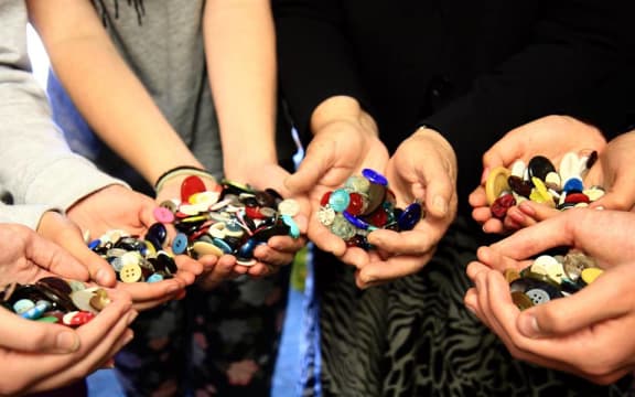 Buttons for the Children's Holocaust Memorial serving as a reminder to stand up against prejudice discrimination and apathy.
