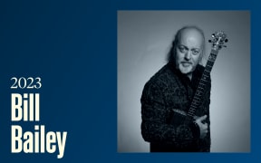 A staring bearded man holding a banjo, text reads "2023, Bill Bailey"