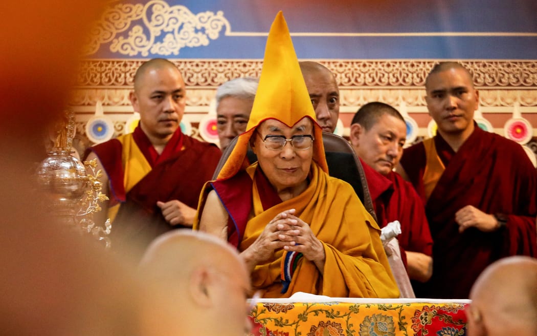 Tibetan spiritual leader the Dalai Lama (C) attends a Long Life Prayer offering ceremony at the Main Tibetan Temple in McLeod Ganj, near Dharamsala on June 30, 2025. Exiled Tibetan spiritual leader, the Dalai Lama, gave on June 30, the strongest indication yet that the 600-year-old institution would continue after his death, at prayer celebrations for his 90th birthday. The leader, who turns 90 on July 6, is according to Tibetans the 14th reincarnation of the Dalai Lama. (Photo by Sanjay BAID / AFP)