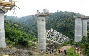Rescue workers conduct a search operation at the site of an accident where an under-construction railway bridge collapsed in Sairang town of the Aizwal district in India's eastern state of Mizoram on August 23, 2023. At least 17 labourers working on a railway bridge being built across a ravine in India's eastern Mizoram state were killed when it collapsed on August 23, officials said, with others reported missing. (Photo by AFP)