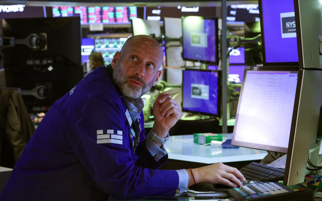 Traders work on the floor of the New York Stock Exchange (NYSE) at the opening bell on April 9, 2025, in New York City. Wall Street stocks were mixed in early trading Wednesday as markets digested the latest tariff hike by the United States and retaliatory moves by China and the European Union.