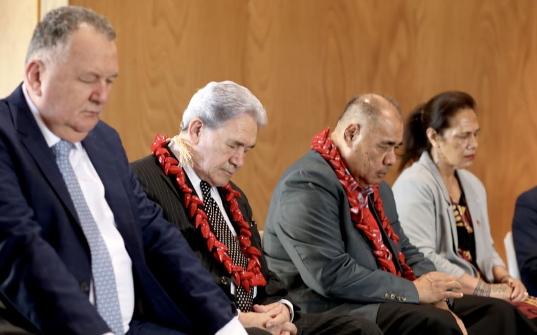 Shane Jones, left, and Winston Peters, centre, during a minute of silence for the Māori king, Kiingi Tuheitia Pootatau Te Wherowhero VII, in Auckland on 30 August 2024.