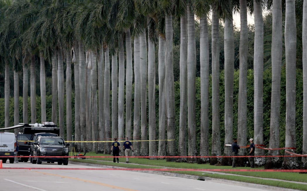 Law enforcement personnel investigate the area around Trump International Golf Club after an apparent assassination attempt of former President Donald Trump on September 15, 2024 in West Palm Beach, Florida.