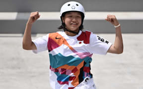 Japan's Momiji Nishiya celebrates after performing a trick during the skateboarding women's street final of the Tokyo 2020 Olympic Games at Ariake Sports Park in Tokyo on July 26, 2021.