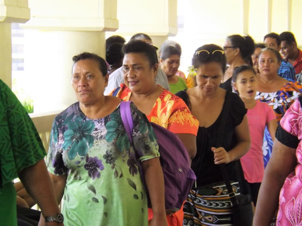 Leutogi Te'o (second from right in the orange puletasi) leaves the courthouse in Apia.
