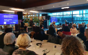 Audience and speakers at a Women in Leadership symposium, Auckland