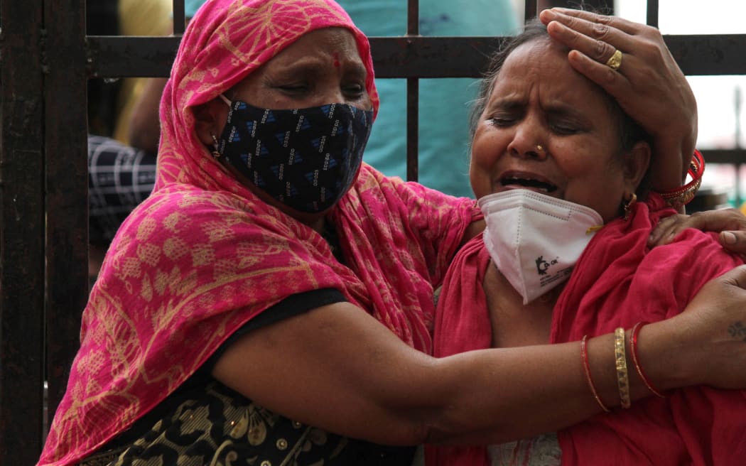 Women mourn the death of a family member, who died due to the coronavirus disease (COVID-19), outside the Lok Nayak Jai Prakash Narayan Hospital (LNJP), one of the largest facilities for coronavirus disease (Covid-19) patients, in New Delhi, India on May 4, 2021.