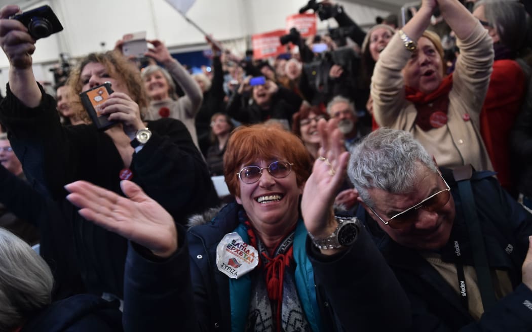 Anti-austerity Syriza supporters celebrate after the first exit polls in Athens on 26 January 2015.