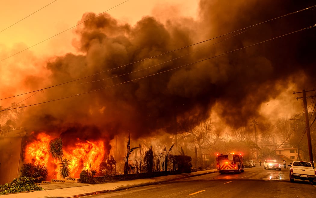 An apartment building burns during the Eaton fire in the Altadena area of Los Angeles county, California on January 8, 2025. - At least five people are now known to have died in wildfires raging around Los Angeles, with more deaths feared, law enforcement said January 8, as terrifying blazes leveled whole streets, torching cars and houses in minutes.
More than 1,000 buildings have burned in multiple wildfires that have erupted around America's second biggest city, forcing tens of thousands of people from their homes. (Photo by JOSH EDELSON / AFP)