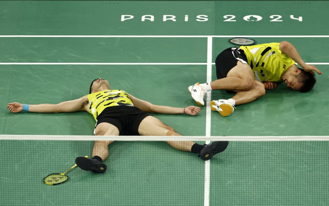 Taiwan's Wang Chi-lin (L) and Lee Yang celebrate winning the men's doubles badminton final match against China in Paris.