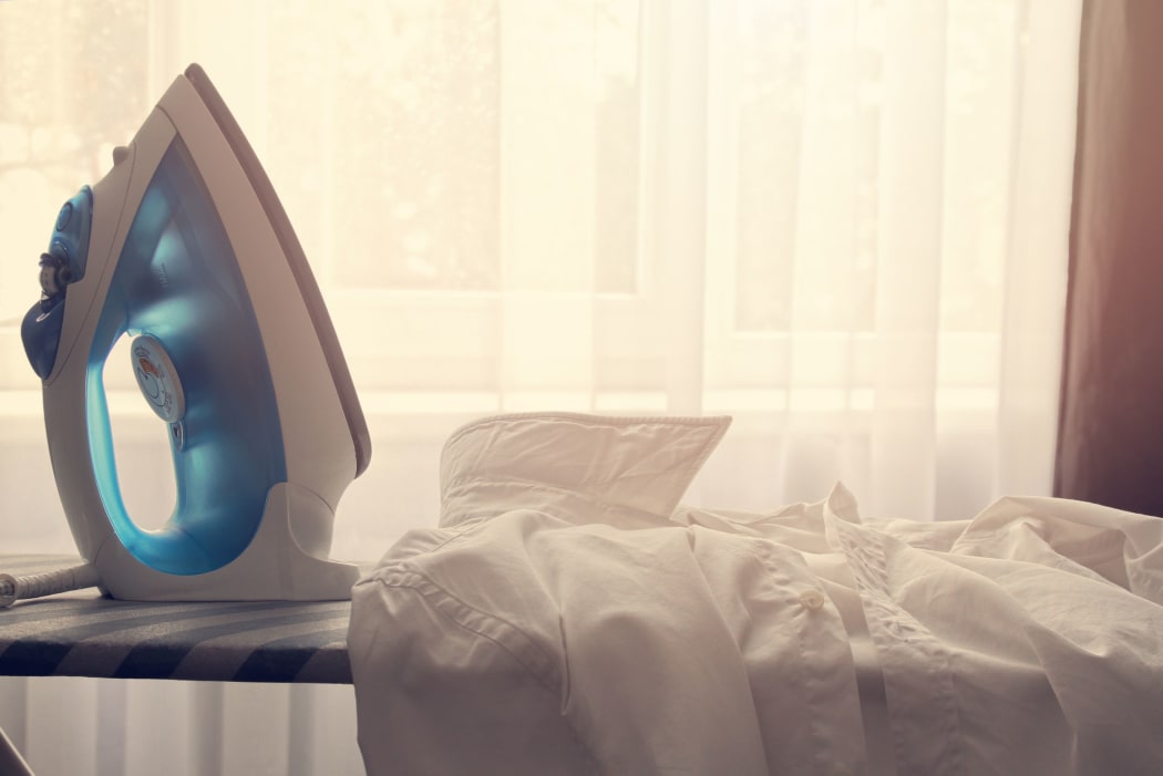 35347873 - white collar shirt and iron on ironing board
