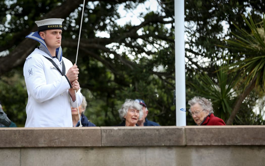 A soldier lowering the flag at the National War Memorial in Wellington.