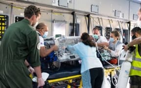 A baby is flown on a special French military flight  from French Polynesia to New Zealand for urgent surgery.