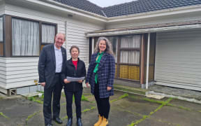 Nelson City Councillor Rachel Sanson Nelson Tasman Housing Trust director Carrie Mozena and Nelson mayor Nick Smith outside the Waimea Road property that will be demolished