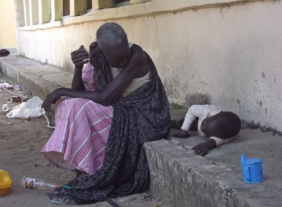 A woman and child outside the main hospital in Bor on Christmas Day.