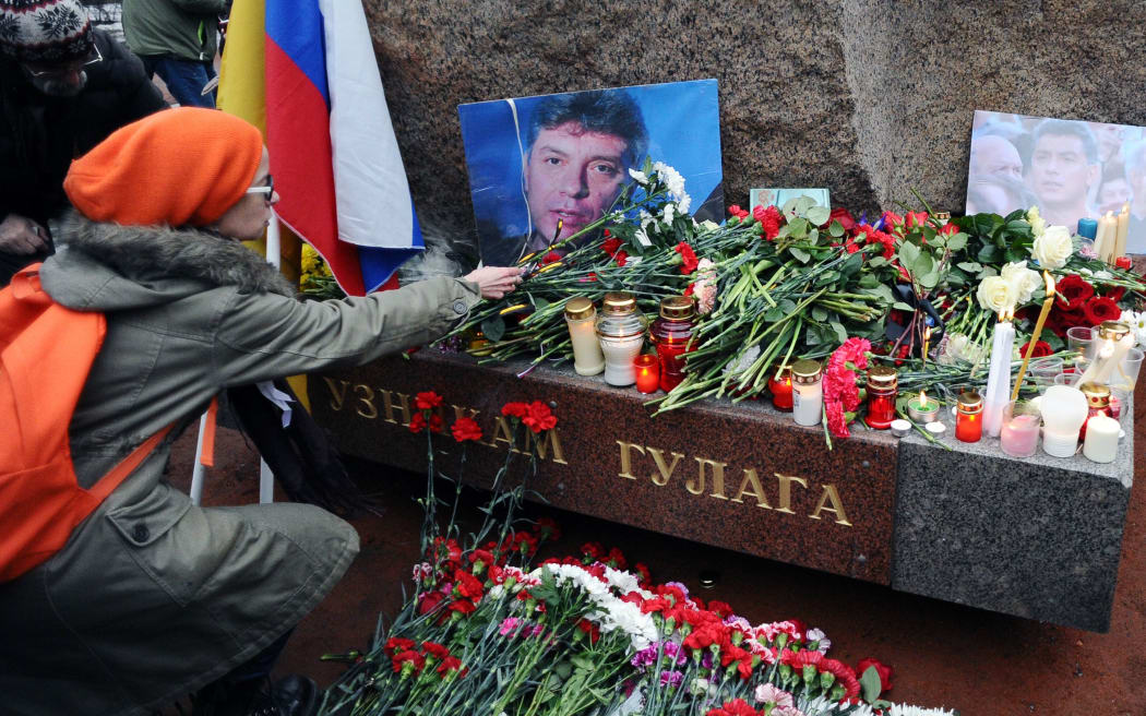 A woman places flowers on February 28, 2015 in memory of Russian opposition leader Boris Nemtsov