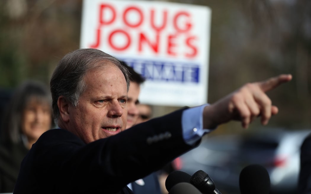 Democratic senatorial candidate Doug Jones speaks to reporters after voting.