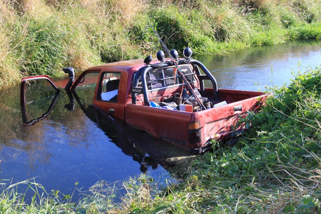 The vehicle as the boys found it in the river with the driver unconscious inside.