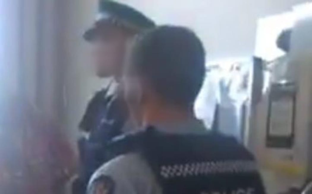 Police standing in the room with the family at Auckland City Hospital.
