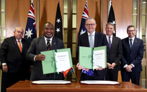Australia's Prime Minister Anthony Albanese (centre R) and Papua New Guinea's Prime Minister James Marape (2nd L) pose with Papua New Guinea's Minister of Foreign Affairs Justin Tkatchenko (L), Australia's Minister of Defence Richard Marles (2nd R) and Australian Minister of Defence Industry and Pacific Island Affairs Pat Conroy (R) after the signing of the Pukpuk treaty at Parliament House in Canberra on October 6, 2025. Australia and Papua New Guinea are to sign a long-awaited mutual defence treaty, as Canberra seeks to deepen ties with Pacific nations and counter Beijing's rising influence. (Photo by DAVID GRAY / AFP)