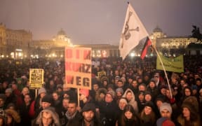 Protesters take part in a demonstration against the current Austrian government at the Heldenplatz in Vienna.