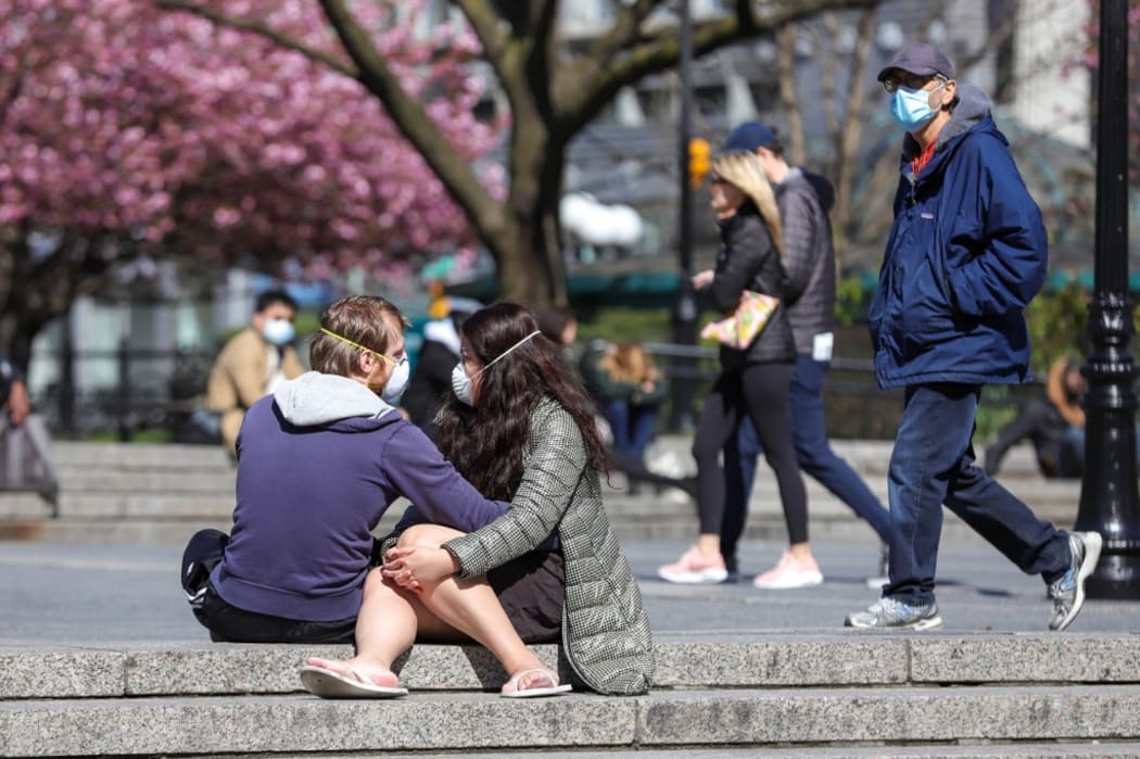 Couple is vito with protective mask in Union Square in Manhattan in New York City in the United States ,  New York City is the epicenter of the Coronavirus pandemic (COVID-19).