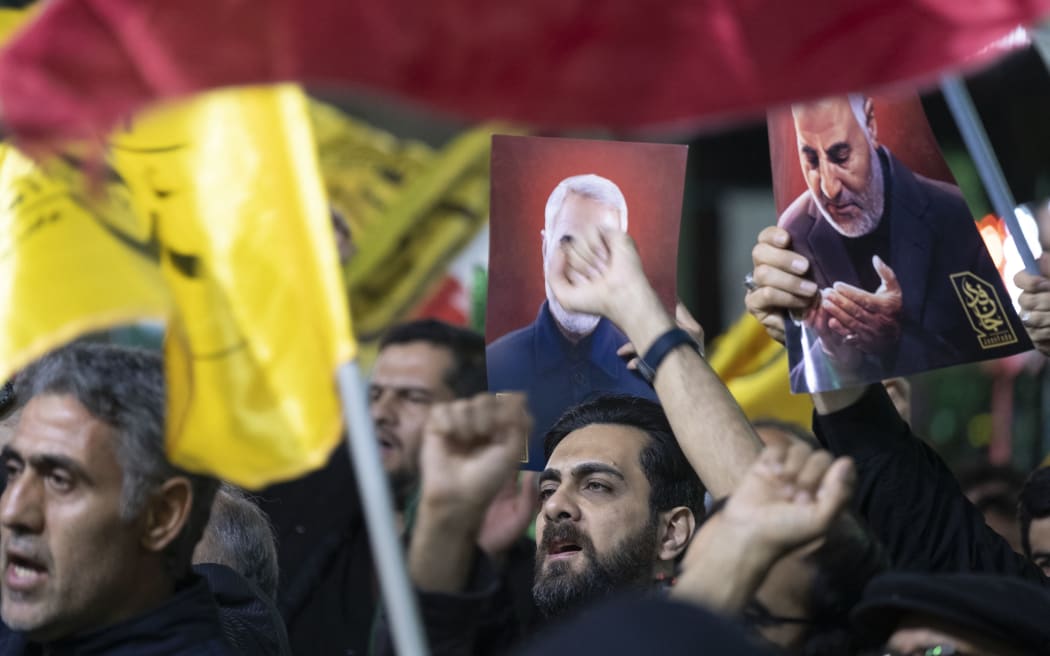 Iranian protesters are shouting anti-Israeli and anti-U.S. slogans while holding up portraits of the former commander of the Islamic Revolutionary Guard Corps' (IRGC) Quds Force, General Qassem Soleimani, during a protest gathering to condemn the Israeli air strike against the Iranian consulate in Syria, at Palestine Square in Tehran, Iran, on April 1, 2024. Mohammad Reza Zahedi, a senior commander in the Iranian Revolutionary Guards Corps (IRGC) Quds force, and his deputy, Mohammad Hadi Haji Rahimi, were killed in an Israeli air strike on the Iranian consulate in Damascus.