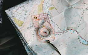 A map with a compass on top if it.
