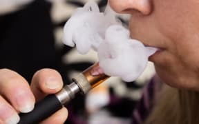 Woman smoking e-cigarette, vaping.