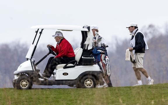 STERLING, VIRGINIA - NOVEMBER 21: US President Donald Trump golfs at Trump National Golf Club on November 21, 2020in Sterling, Virginia.
