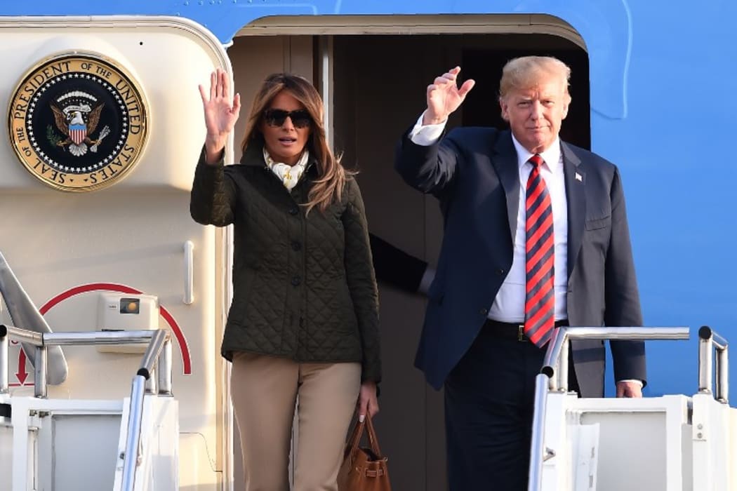 US President Donald Trump waves as he disembarks Air Force One with US First Lady Melania Trump at Prestwick Airport, south of Glasgow on 13 July, 2018.